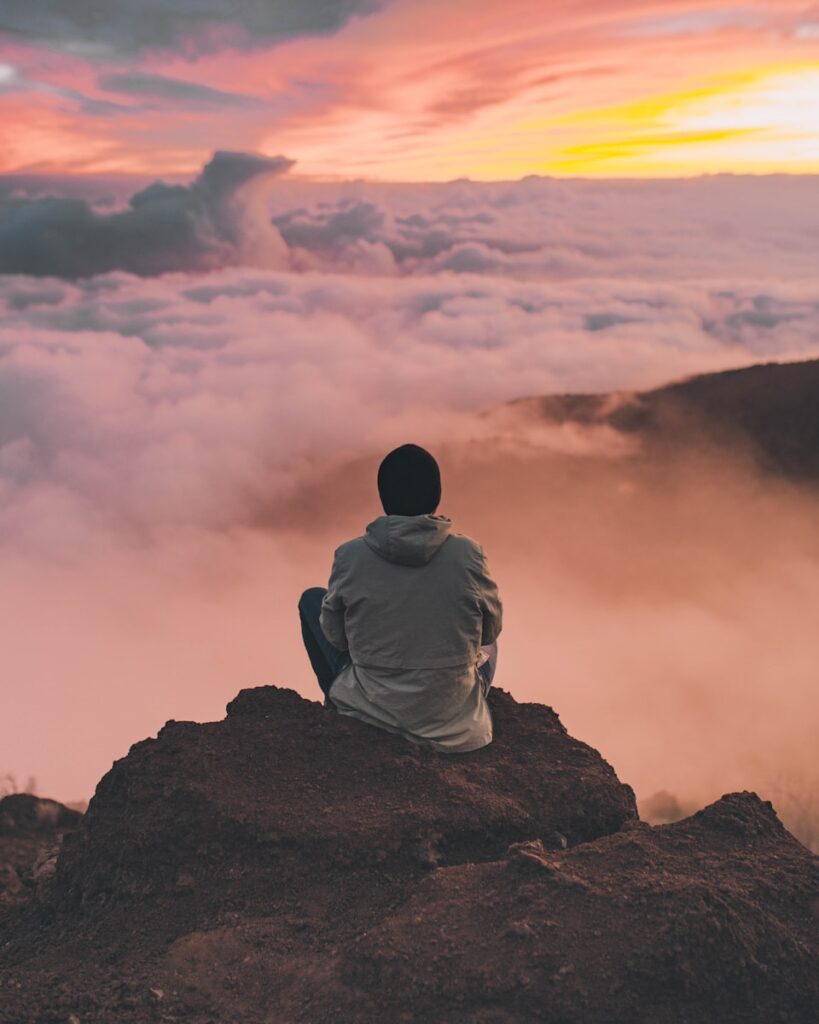 man sitting on cliff